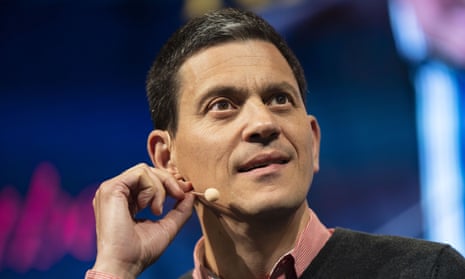 David Miliband on stage at the Hay festival, with a small microphone attached to his ear