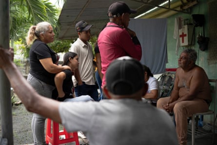 Adolfo Guedez talks with relatives who have travelled from a different village to pay their respects during Alexandra’s funeral in Poblado Uno