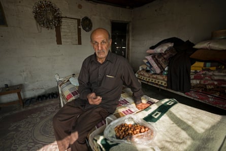 Jassem Hossen Al Hameria, a prisoner during the Iran-Iraq conflict, squatting in building that was part of a military camp under Saddam Hussein.