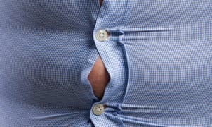 Overweight man wearing blue shirt with bulging buttons