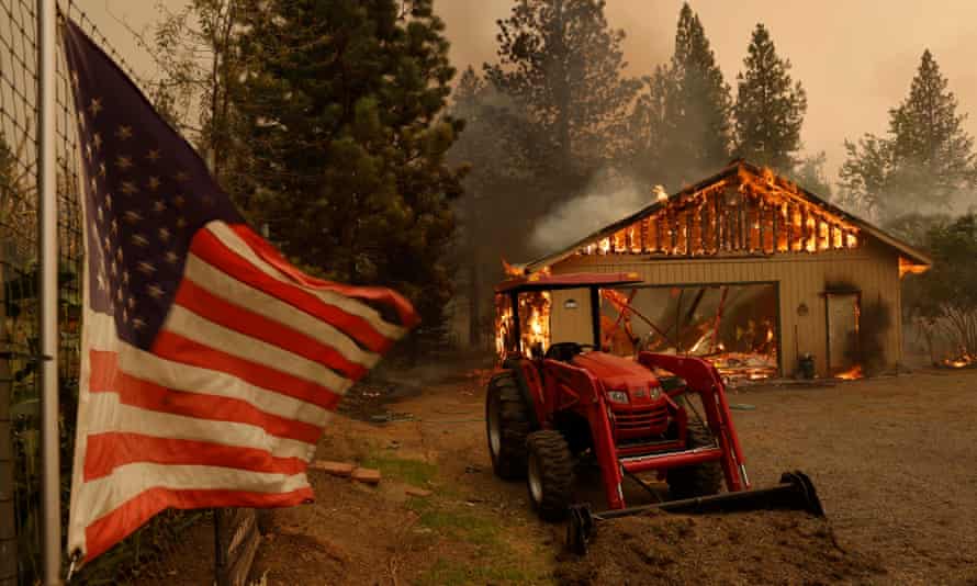 A structure is engulfed in flames from the Dixie fire near Taylorsville, California Friday.