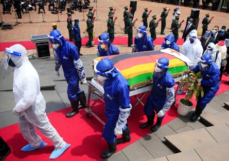 Pallbearers carry a coffin at the burial of two cabinet ministers and a retired general who died after contracting the coronavirus disease (COVID-19) in Harare, Zimbabwe