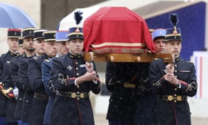 Arnaud Beltrame’s coffin is carried during the ceremony at the Hotel des Invalides in Paris.