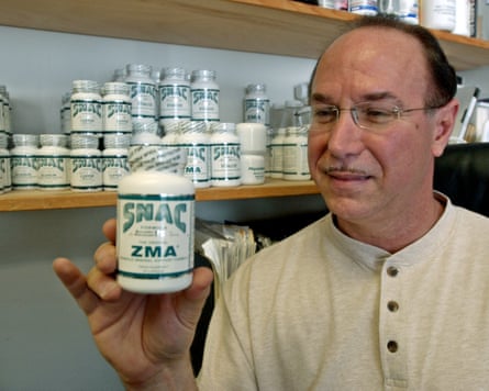 Victor Conte holds up one of the drugs he sold, at his office in Burlingame in 2003