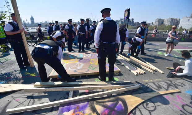 Police dismantle the skate ramp erected by Extinction Rebellion demonstrators on Waterloo Bridge in London.