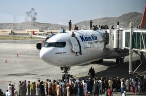 People climb atop a plane