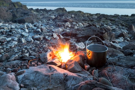 Fire with Cooking Pot on a Rocky Beach in England, UK
