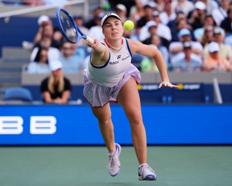 Linda Noskova reaches to return the ball to Aryna Sabalenka.
