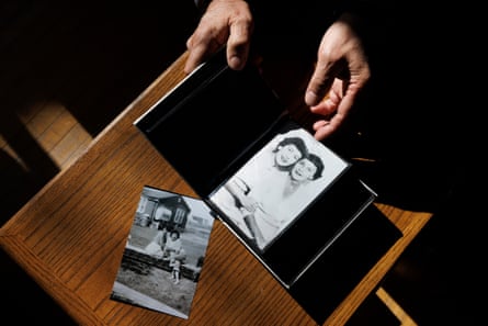 Eddy Ambrose leafs through a photo album featuring pictures of his biological mother and aunt, neither of whom he knew.
