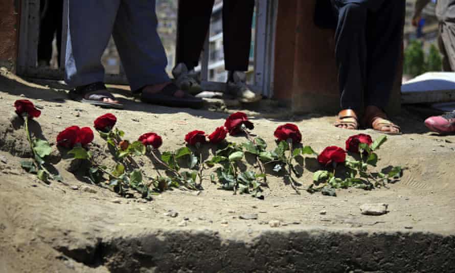 People puts flowers outside a school on Sunday after the attack