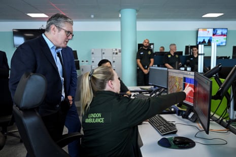 Keir Starmer listening to a demonstration by Siobhan Jones-Evans, a member of the 999 control room, during his visit to an Emergency Operations Centre (EOC) at London ambulance service dockside centre in London this morning.