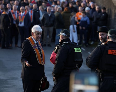 Nigel Dawson, known as district master of Portadown Loyal Orange Lodge, speaks to a police officer.