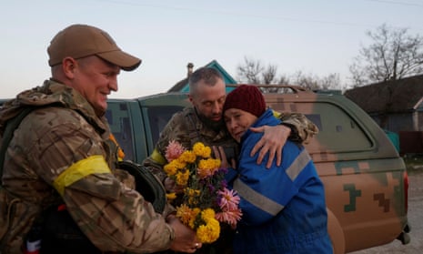 Local resident Valentyna Buhaiova embraces Ukrainian marines in the recently retaken village of Kyselivka, outside of Kherson, Ukraine.