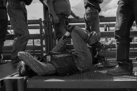 A man lying connected a metallic level holding his knee