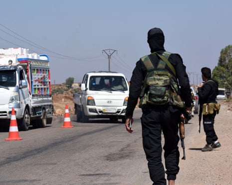 Syrian government security forces man a checkpoint, to prevent Beduin tribal fighters from reaching the city of Sweida, along a road in southern Syria's Sweida province on 19 July 2025.
