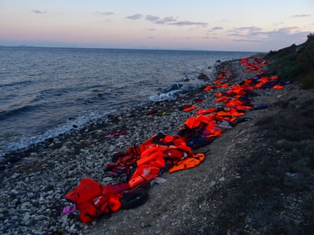 An orange rind of lifejackets, visible from the air, lines the fatal rocks of Lesbos
