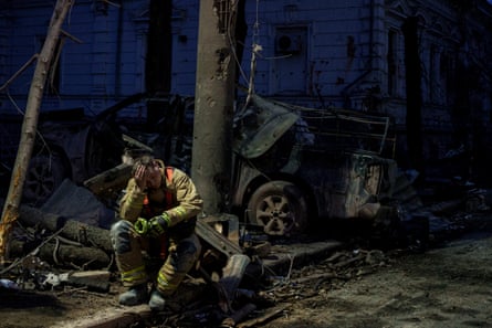 A rescue worker rests near a university building destroyed by a Russian missile strike on Sumy in April.