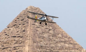 A Stampe OO-GWB biplane is flown over a Giza pyramid by Yasser Menaissy and Cedric Collette last week in the Vintage Air Rally.