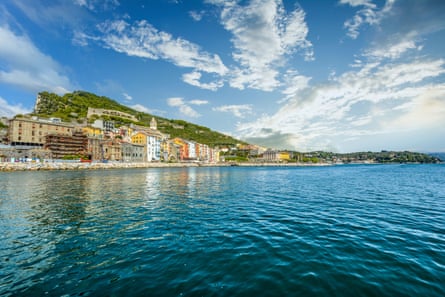 Colouful Italian village sits on a calm blue sea