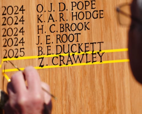 A painter adds the name of Zak Crawley to the board of Test centurions at Trent Bridge