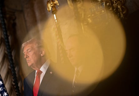 Donald Trump in front of US flags.