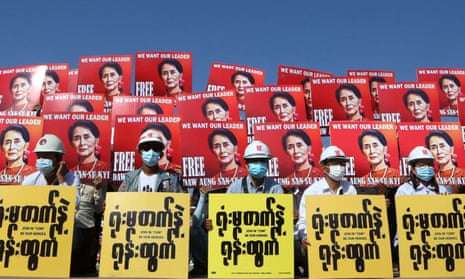 Coup demonstrators hold placards with the image of Aung San Suu Kyi in Naypyitaw, Myanmar, on Monday.
