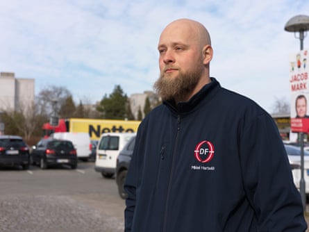 DPP candidate Mikkel Hartwich, a bald man with a beard wearing a jacket with his own name on it