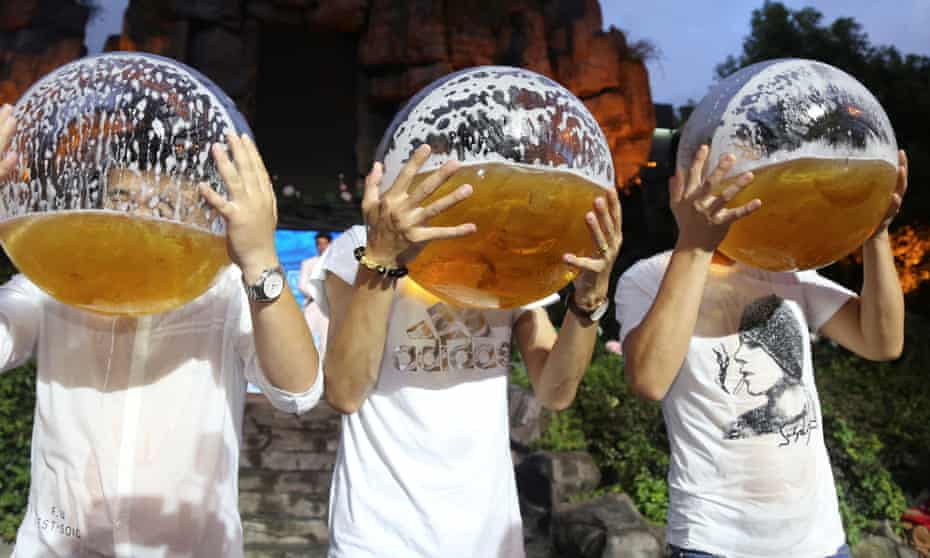 People drink beer from fish bowls at a beer drinking competition in Hangzhou in China.