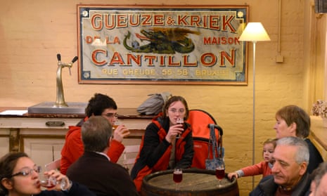 Visitors enjoy beers at the Cantillon brewery in Brussels. The brewery follows traditional way to brew lambic style beers but this is at risk with warmer weather.