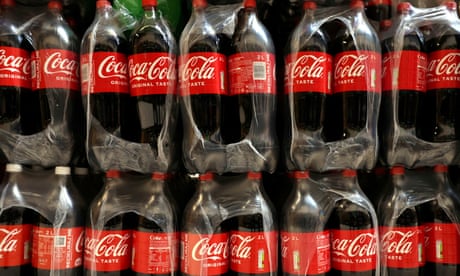 Bottles of Coca-Cola on a shelf in a supermarket