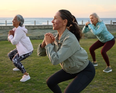 Smiling woman doing exercise with friends.