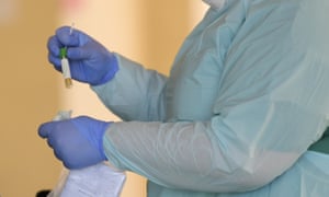 A medical worker carries out a coronavirus test