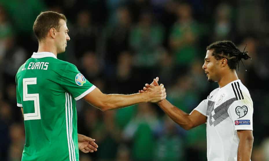 Serge Gnabry shakes hands with Jonny Evans at the end of the match.
