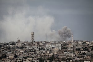 Smoke rises after a bomb hit on a village in Idlib province