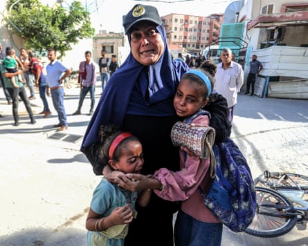 A woman and two children crying