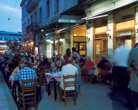 A street filled with dining tourists in the Plaka district
