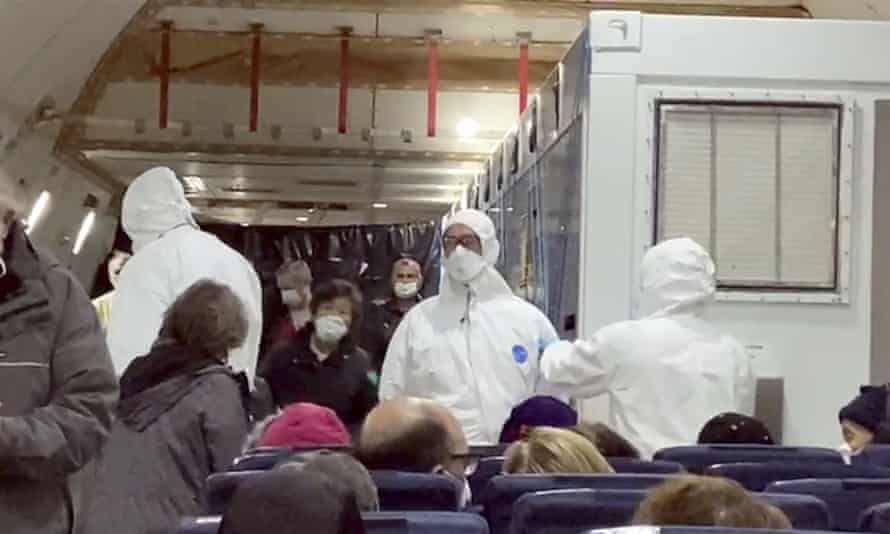 Image from a video taken on 17 February shows American passengers who were evacuated from the Diamond Princess cruise ship on a plane bound for the US.