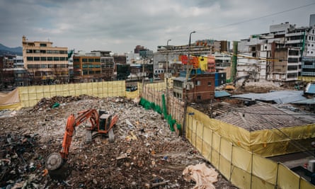 Excavators dig out debris of demolished buildings, Euljiro, Seoul.