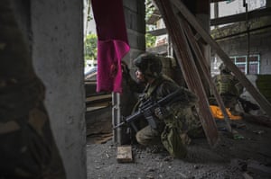 A soldier gazes out towards enemy positions in Marawi