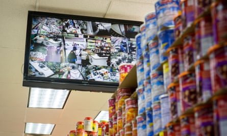 A monitor shows the video feeds of security cameras in a supermarket.