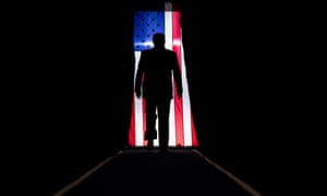 Donald Trump silhouetted against a US flag