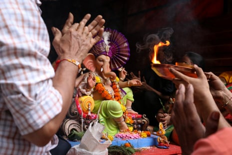 The Naikude family performing a prayer to their Ganesh idol