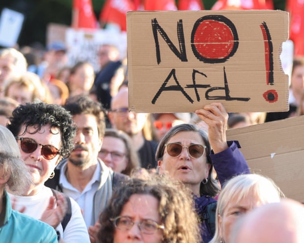 An anti-AfD protest with a woman holding a sign saying 'No Afd'