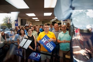Supporters watch Joe Biden deliver remarks in his campaign office in Iowa City, Iowa, on 7 August 2019.