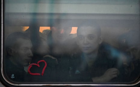 Russian conscripts called up for military service look out of a train window before their departure for garrisons at a railway station in Omsk, Russia in November.