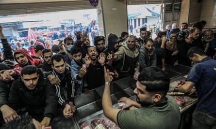 People jostling to buy meat in Rafah on Saturday.