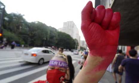Woman with hand painted red takes part in International Women's Day protests in Sao Paulo in March.