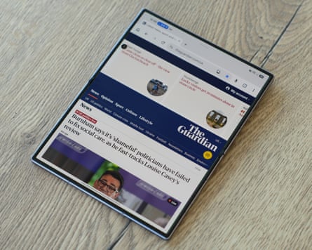 The Samsung Galaxy Z Fold 8 showing the Guardian website in portrait orientation.