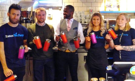 Austin Cohen (centre) with people in the Boston Tea Party cafe holding mugs which are being handed out to those who are street homeless in Salisbury