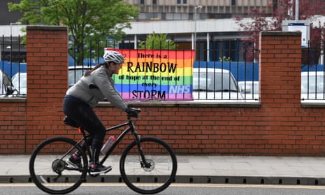 A cyclist passes a rainbow banner outside Salford Royal Hospital last week.
